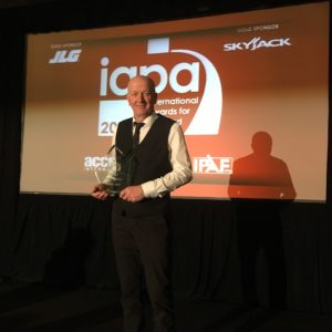 Peter Wallace holding iapa award